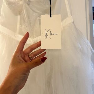 White corset onesie bridal dress. Tool and lance on bottom, strapless.